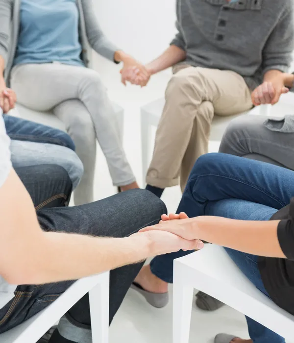 lost angels group therapy people sitting circle holding hands
