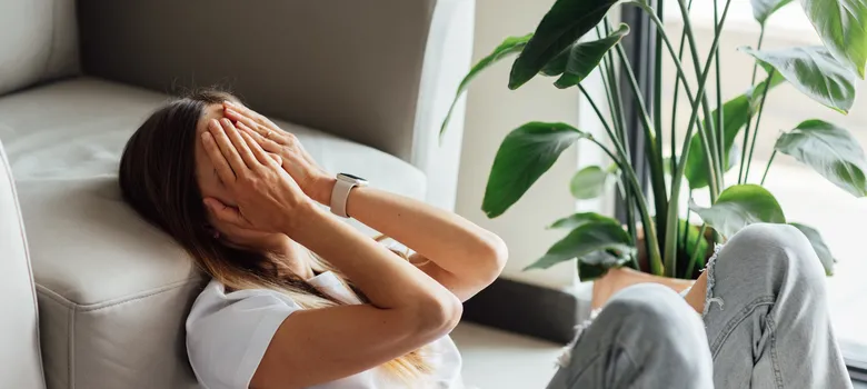 lost angels mental health woman sitting couch head hands