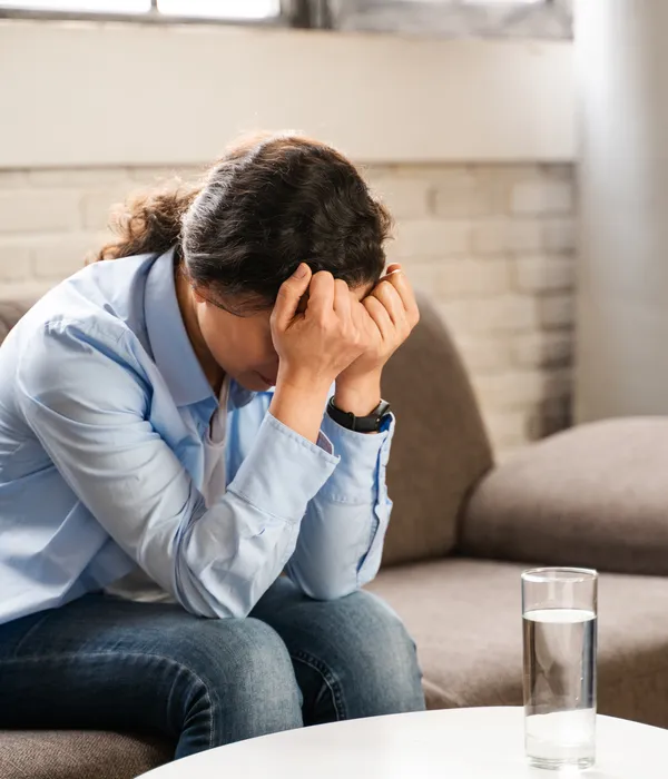 lost angels mental health woman sitting couch head hands