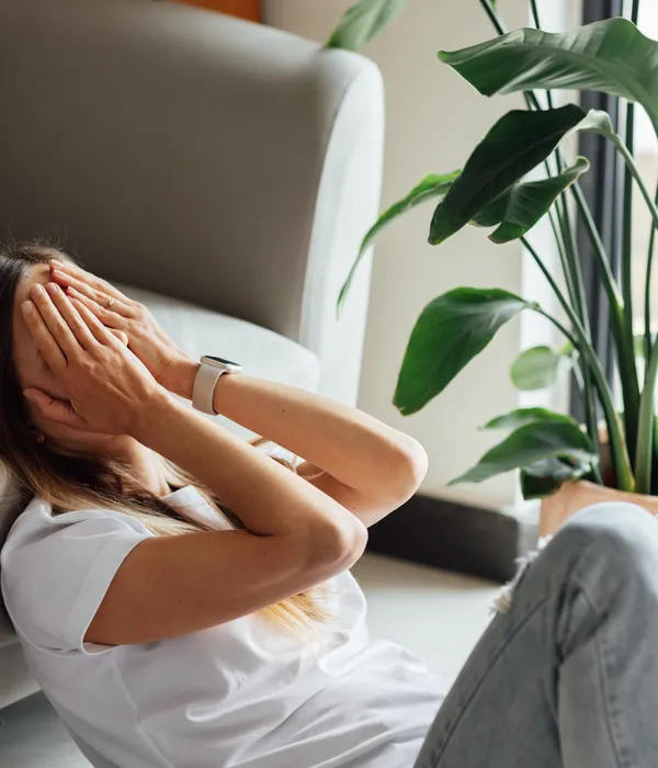 lost angels mental health woman sitting floor hands face