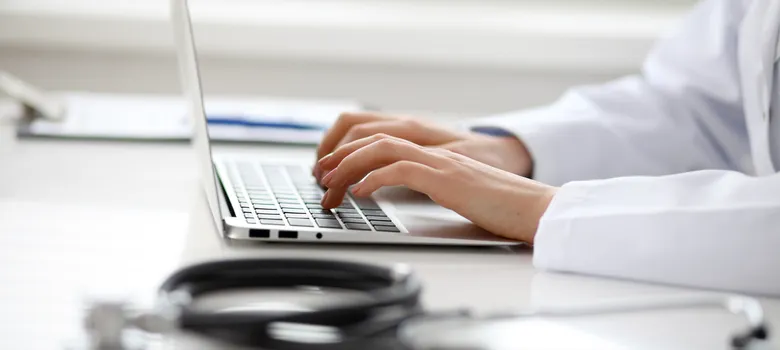 lost angels prescription drug doctor typing laptop computer