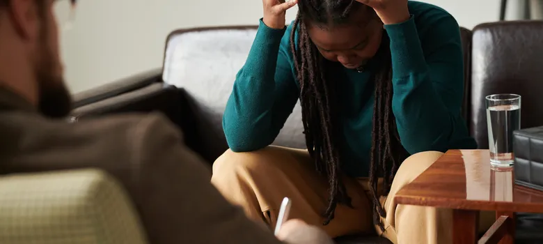 lost angels therapy woman sitting couch head hands