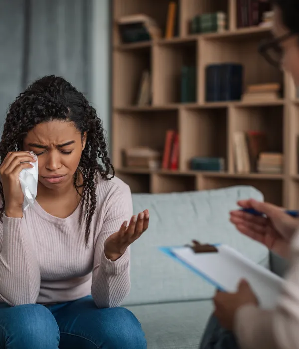 depressed-young-black-lady-crying-consultation-with-european-page