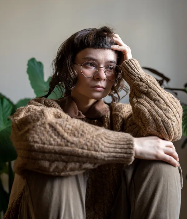 portrait-young-woman-standing-against-plants-page