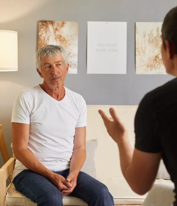 senior-man-white-tshirt-talking-psychologist-mental-health-page