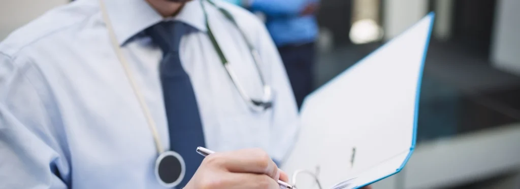 doctor writes a medical report about inpatient treatment