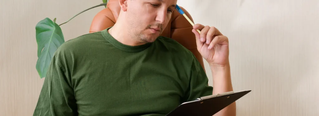 Man thinking about how his responsaibilities are affected by alcohol addiction.