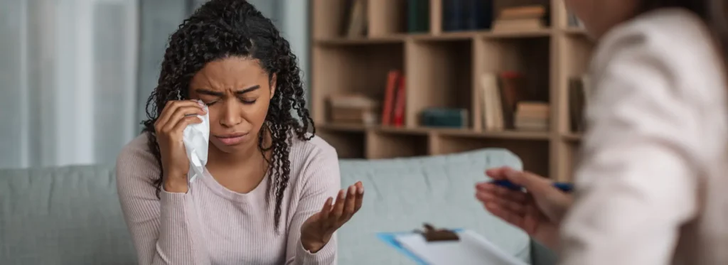 A woman being sad in the middle of therapy due to cocaine hangover. 