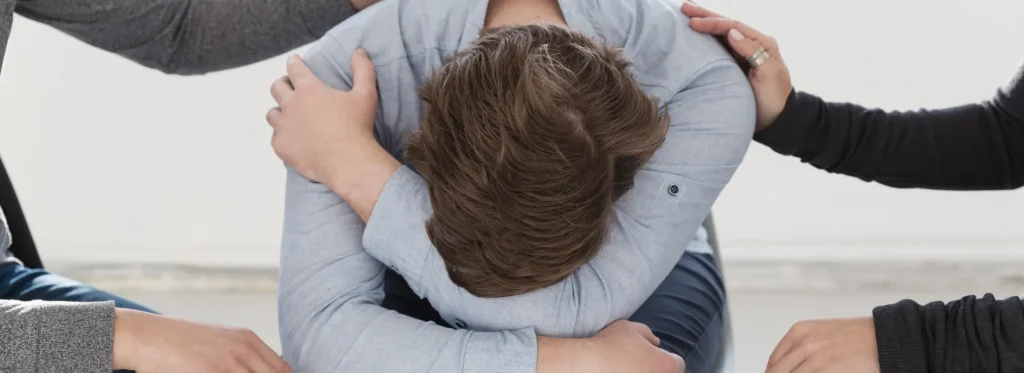 Man getting comforted during therapy.