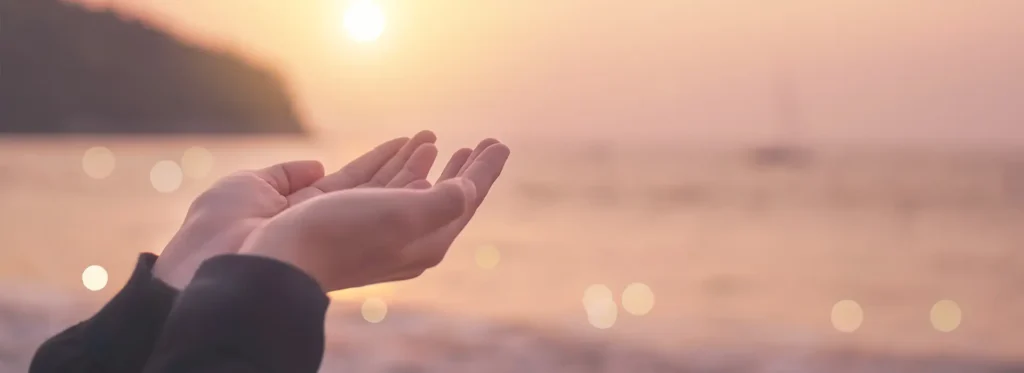 Person holding their hands up getting heat from the sun.